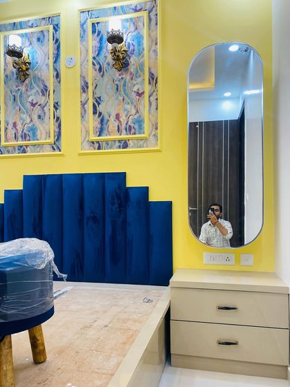 A close-up of the dressing table area in the master bedroom, with a sleek oval mirror and drawers for storage.