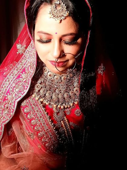 This profile view showcases the contouring and highlighting that defines her features. The makeup is designed to look beautiful from every angle.