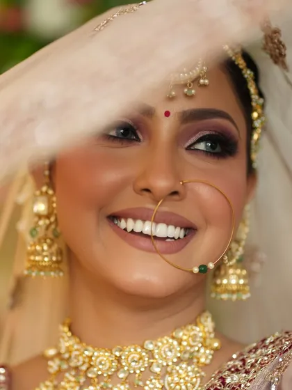 The same bridal look, but with a beautiful, wide smile. This shows how the makeup looks both serene and joyful.