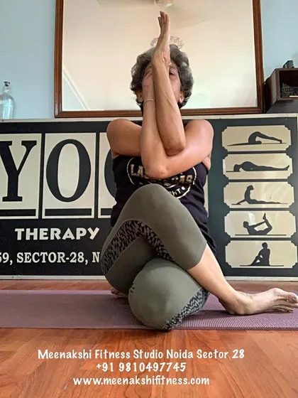 The arm variation of Gomukhasana, known as Eagle Arms (Garudasana arms), which deeply stretches the upper back and shoulders.