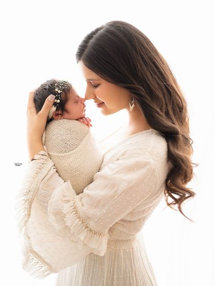 A beautiful profile shot of a mother and her newborn, capturing a quiet moment of connection.