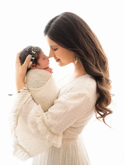 A beautiful profile shot of a mother and her newborn, capturing a quiet moment of connection.