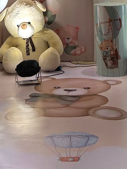 The floor vinyl is custom printed with teddy bears and hot air balloons, ensuring that the theme extends to every surface for a complete look.