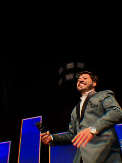 Holding the mic, ready for the next move. This shot captures the anticipation and excitement of a live performance.
