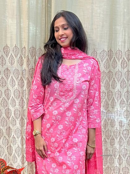 This pink printed suit set is a festive favorite. The straight-cut kurta is paired with a matching dupatta, creating a look that is both simple and elegant.