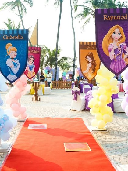 A royal walkway lined with princess banners for Cinderella, Belle, and Rapunzel, making every guest feel like royalty.