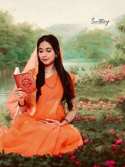 The full-color version of our Ram-Sita inspired portrait. The mother-to-be, in a saffron-colored saree, reads by the water, creating a scene of tranquility and grace rooted in mythology.