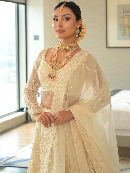 A bridal glow in all white. This look is crafted to perfection, with soft, glowing skin and defined eyes that enhance the bride's features beautifully.