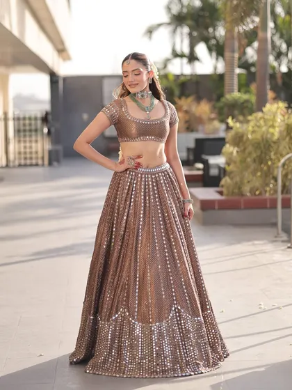 The versatility of this bronze lehenga makes it suitable for various wedding events. Here, the bride looks effortlessly chic, proving that the right outfit can make you feel confident and beautiful.