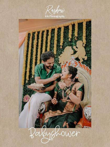 A joyful, candid moment from a baby shower ceremony. The husband is playfully feeding his wife a sweet, and their smiles show the fun and love shared during the event.