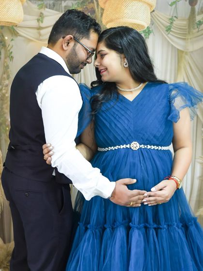 An intimate moment between a couple in our boho studio. They are touching foreheads, sharing a quiet connection.