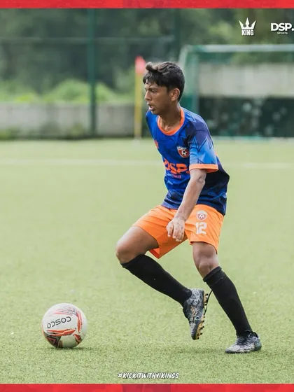 Dribbling with purpose. A player advances the ball up the field during a practice match.