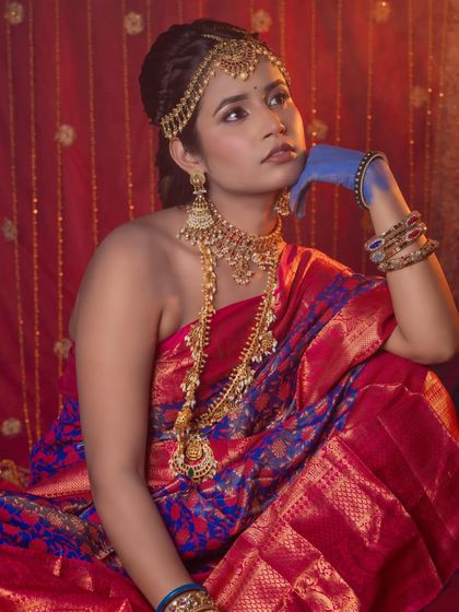 A full-seated artistic pose, this image highlights the contrast between the traditional jewellery and the modern styling.