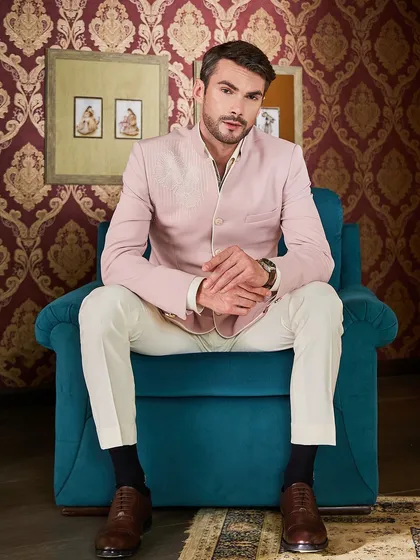 The full look of the pink Jodhpuri, paired with ivory trousers and classic brown leather shoes. It’s a fresh, modern take on traditional formalwear.