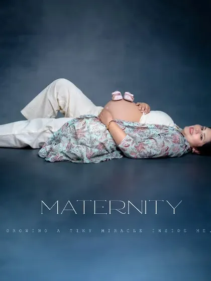 A creative and artistic portrait celebrating the little life on the way. The tiny shoes resting on the baby bump symbolize all the dreams and hopes for the future, captured in a beautifully styled studio maternity photo.