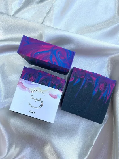 This is Onyx, a soap with a dramatic and bold design. The deep black is contrasted with vibrant streaks of pink and blue.