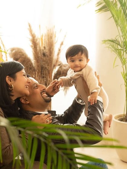 A candid moment of play during a multi-generational family shoot. A father lies back while his child reaches for him, showing the fun and relaxed atmosphere of my studio.