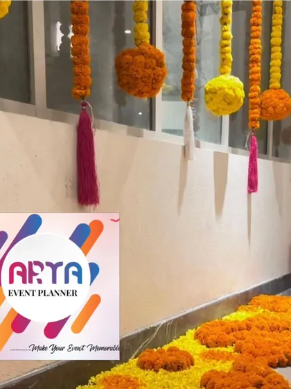 A simple yet traditional decoration for a home event, featuring hanging garlands of yellow and orange marigolds. This is a classic and auspicious way to decorate a space for any celebration.