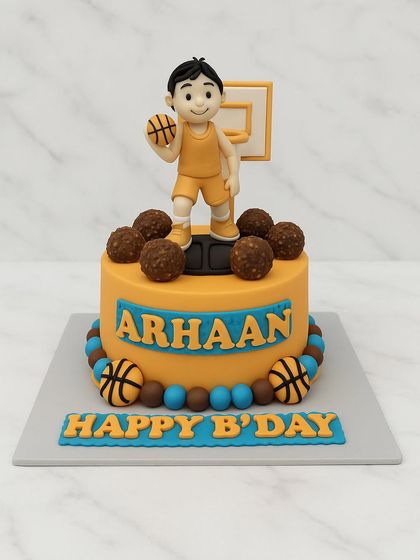 A slam dunk of a cake for a basketball fan's birthday. This design features a fondant basketball player, a hoop, and chocolate Ferrero Rocher basketballs, all personalized with the birthday boy's name.