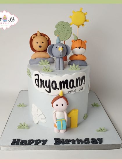 A wild one! This cute and simple jungle-themed cake is perfect for a first birthday. It's topped with adorable, minimalist fondant animals like a lion, elephant, and fox.
