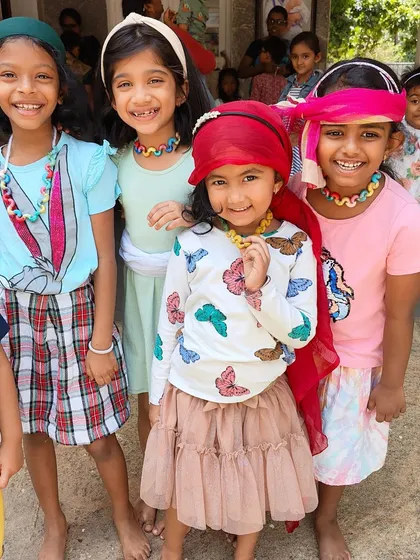 Dressing up and making colorful necklaces during our summer camp. These activities encourage self-expression and help develop fine motor skills in a playful environment.
