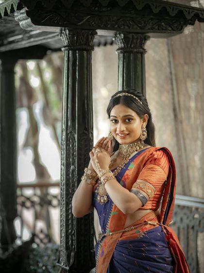 A happy and inviting portrait, the model's smile as warm as the colors of her saree.
