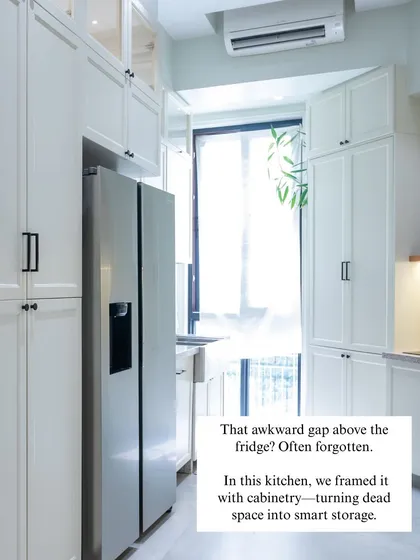 The awkward gap above the fridge is often forgotten. In this kitchen, we framed it with custom cabinetry, turning what was once dead space into valuable and seamless storage.