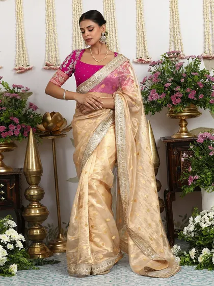 The full view of the gold and pink saree, a beautiful blend of textures and colors.
