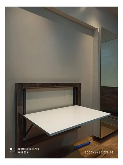 For homes that need a flexible workspace, I build wall-mounted foldable tables like this one in Pune. It serves as a sturdy study desk when you need it and folds flat against the wall when you don't, saving valuable floor space.