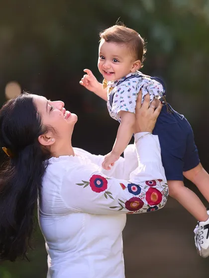 The pure happiness of a mother lifting her son into the air. I encourage playful interactions like this to capture dynamic photos filled with genuine emotion and beautiful natural light.