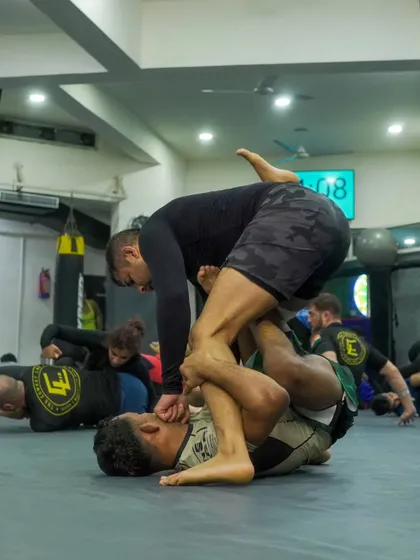 A student executes a guard pass during a No-Gi training session. Learning to navigate and advance through different positions is a fundamental aspect of our submission wrestling curriculum.