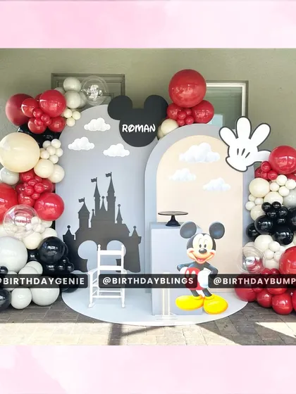 A grand Mickey Mouse Clubhouse theme, featuring a castle silhouette backdrop and a classic Mickey cutout. The red, black, white, and cream balloons create a sophisticated yet fun color scheme.