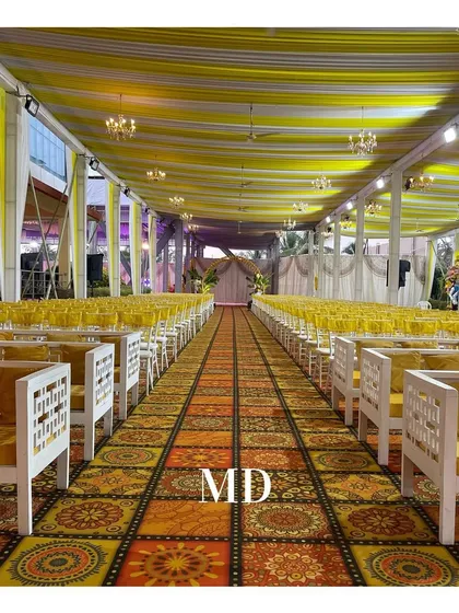 The seating arrangement for a large Haldi ceremony. We used a vibrant, patterned carpet to define the guest area and provided a mix of traditional chairs and comfortable sofa-style seating.