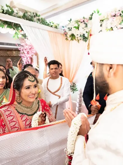 The bride's happy expression as she sees her groom for the first time at the mandap.