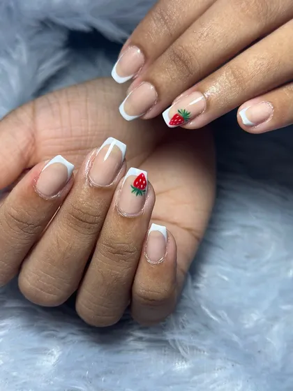 A classic French manicure with a sweet, hand-painted strawberry accent.