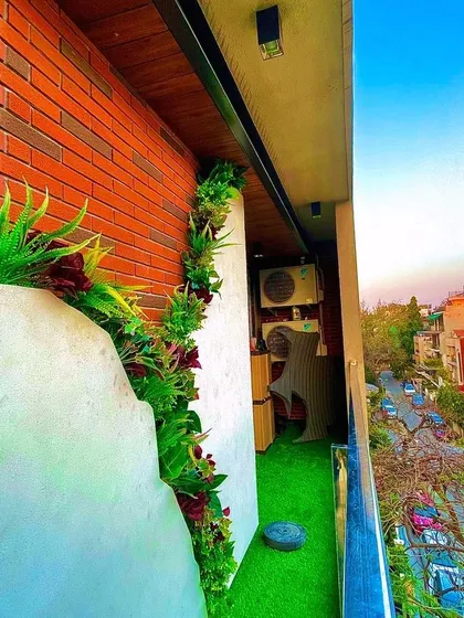 A look at a residential balcony project in South Delhi with a city view. We used a combination of artificial turf and a vertical garden to add a strip of nature to this urban apartment, making the most of a compact space.