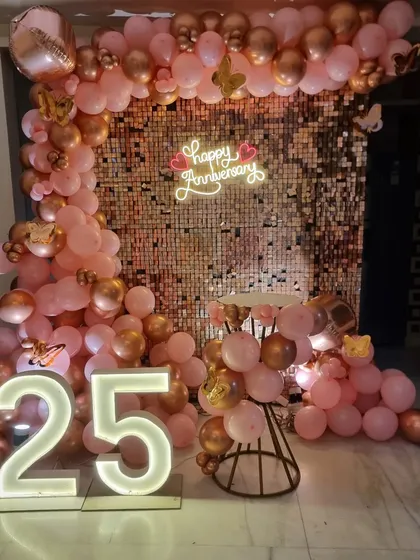 We make milestone anniversaries unforgettable. This 25th-anniversary setup includes a glamorous rose gold sequin wall, a custom "Happy Anniversary" neon sign, and large light-up "25" numbers, creating the perfect backdrop for photos.