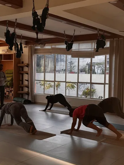 Students practice a plank variation, building core and upper body strength.