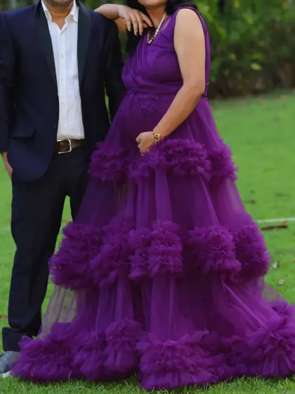 Our purple ruffle maternity gown is designed for both style and comfort. The layers of tulle create a beautiful, full look for your photoshoot.