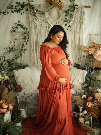 A graceful solo portrait in our earthy boho setup. The mother-to-be's gentle expression and the warm color palette create a serene and beautiful image.
