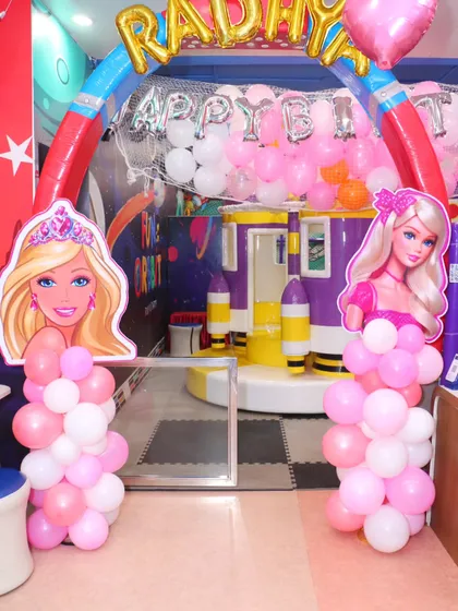 The entrance to the play zone gets a Barbie makeover with themed cutouts and a balloon arch, seamlessly connecting the party area and the playground.