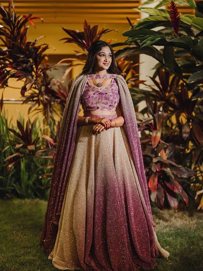 A full-length view of the stunning sangeet lehenga. The hairstyle and makeup are designed to balance the grandeur of the outfit.