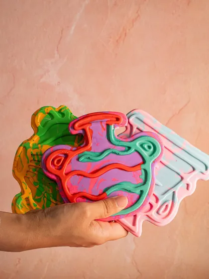 A handful of my colorful, handcrafted soap bars. I make them with natural, toxin-free ingredients, and each one has a unique, artistic design.