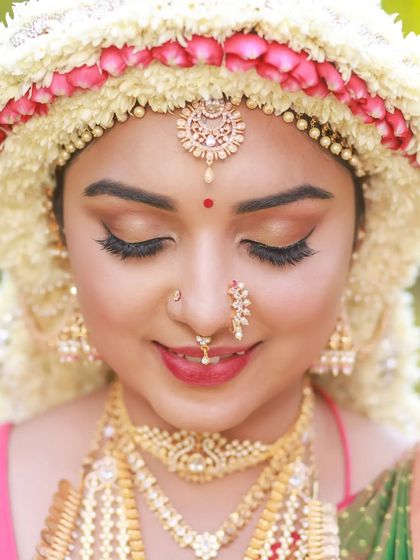 Close-up portraits focusing on the "Sharadha Jalli" hairstyle and bridal makeup. The ring light creates a beautiful, even glow, highlighting the intricate details and the model's features.