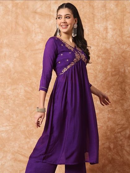 A wine-colored kurta pant set with a flattering A-line silhouette. The thread embroidery on the yoke adds a beautiful detail.