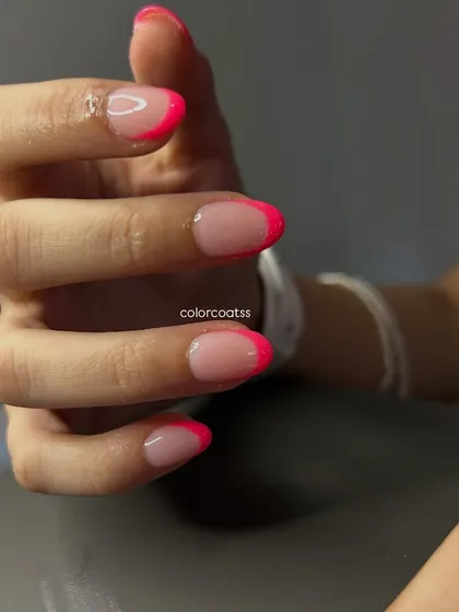 Another angle of these fun neon pink French tips. The high-gloss finish makes the color pop even more, showing how a simple design can make a big statement.