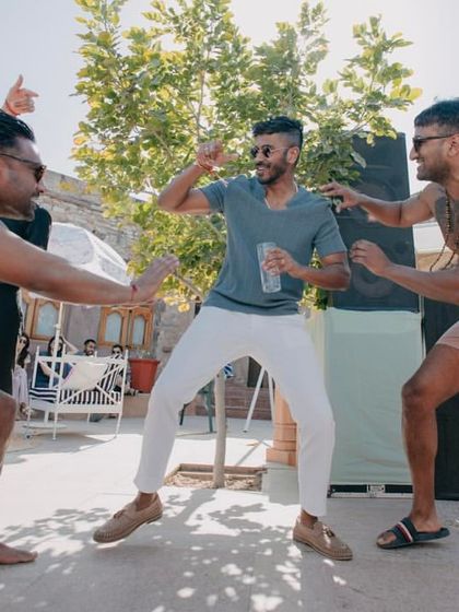 The groom and his friends letting loose and dancing at the fun-filled pool party.