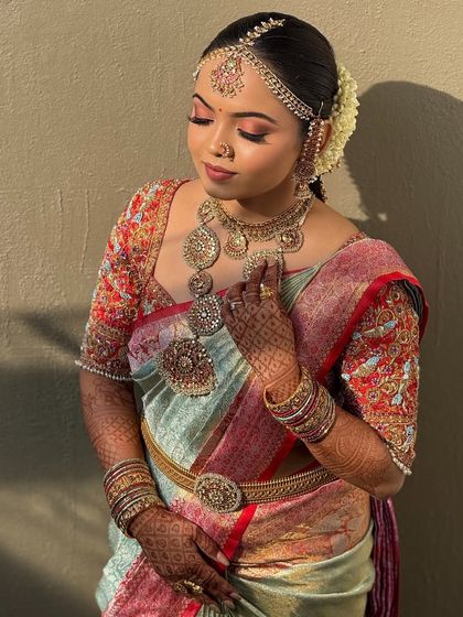 A beautiful shot of the bride in the golden hour light. The warm tones of the makeup are enhanced by the natural light, creating a magical glow.