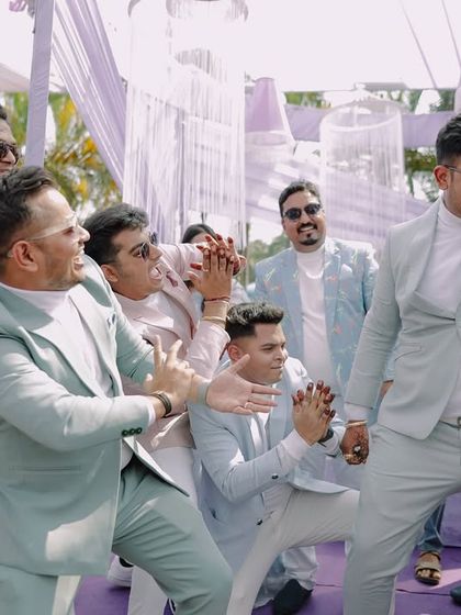 The groom and his groomsmen showing off their dance moves. We love capturing the camaraderie and fun of the groom's squad.