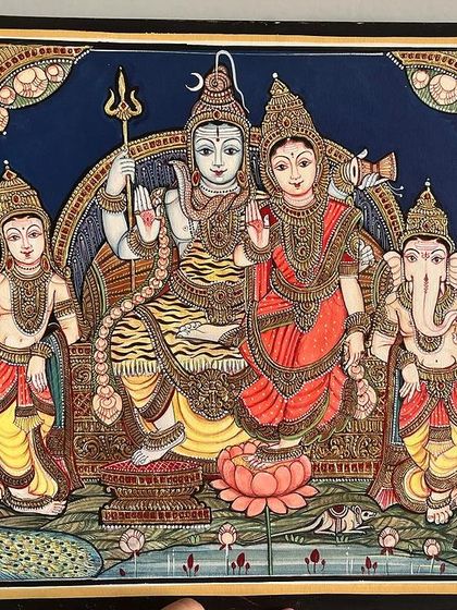 This exquisite Shiva Parvathi Kutumba painting is done in an antique Mysore style. The subtle colors and embossed gold leaf work create a timeless piece showing the divine family.